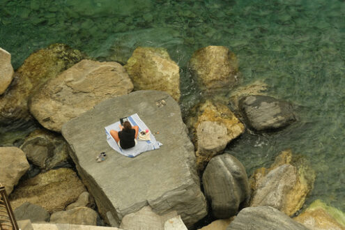 Woman at the sea. Social distancing. Young woman at the sea on the cliff. - MyVideoimage.com | Foto stock & Video footage