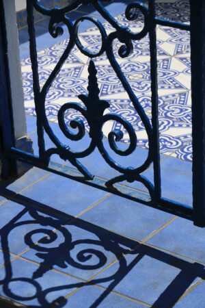 Wrought iron gate. Blue and white ceramic tiles. - MyVideoimage.com